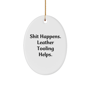 Funny Christmas Unique Gifts from Friends and Family - 'Shit Happens. Leather Tooling Helps.' Oval Ornament for Leather Tooling Enthusiasts, Men, Women, Coworkers, and Family - Image 1