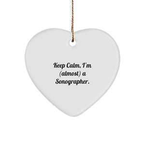 Funny Sonographer Gifts from Friends, Unique Christmas Unique Gifts for Sonographer, Heart Ornament with 'Keep Calm, I'm (almost) A Sonographer.' Quote - White Heart-Shaped Decorative Figurine - Image 1